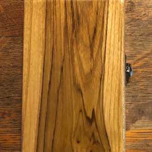 May include: A wooden box with a natural wood finish. The box has a hinged lid and a metal latch.