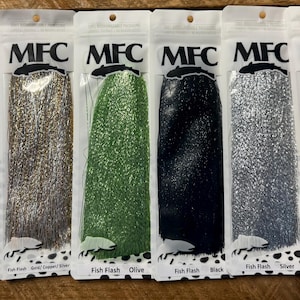 May include: Six packages of MFC brand Fish Flash in various colors, including mottled grey, gold/copper/silver, olive, black, silver, and UV pearl. Each package is sealed and labeled with the product name and a fish graphic.