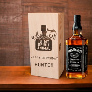Könnte beinhalten: Eine Holzkiste mit einer personalisierten Nachricht, die lautet: "Whiskey ist mein spirituelles Tier. Alles Gute zum Geburtstag Hunter." Die Kiste enthält eine Flasche Jack Daniel's Tennessee Whiskey.