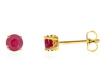 May include: A pair of gold stud earrings with a red ruby gemstone in each earring.