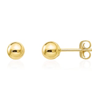May include: A pair of gold ball stud earrings. The earrings are simple and classic, and they would make a great gift for any occasion.