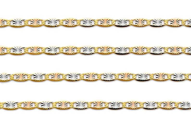 May include: Gold-tone chain necklace with a tri-color design. The chain features alternating oval links with a starburst pattern in gold, silver, and rose gold. The necklace is displayed against a white background.