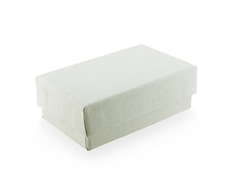 May include: A rectangular, off-white gift box with a textured, swirling pattern. The box has a lid and a base, and is set against a white background. The box is likely for jewelry or small gifts.
