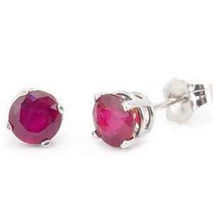 May include: A pair of ruby stud earrings set in silver.