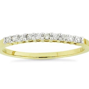 May include: A delicate gold band with a row of small diamonds set in a pave setting.
