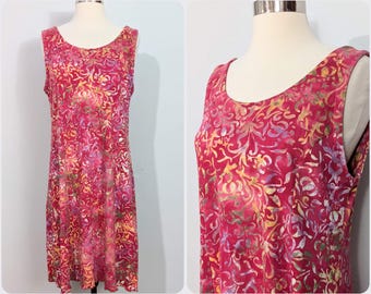May include: A sleeveless, pink, red, and yellow floral print dress with a scoop neck.