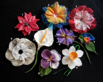 May include: Ten felt flower brooches in various colours and styles, including red, white, blue, orange, purple, and green. The flowers are all handmade and have a unique, textured look.