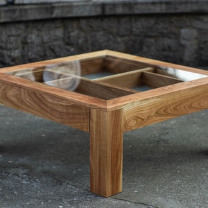 Glass and wood coffee table with drawers and hidden compartments