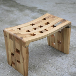 Small curved bench with holes