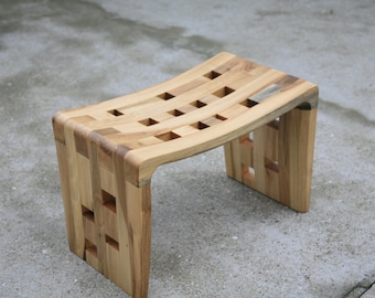 Small curved bench with holes