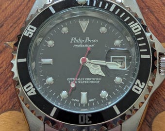 Reloj de pulsera de cuarzo para hombre Philip Persio con bisel giratorio, como nuevo, funcionando y manteniendo la hora.