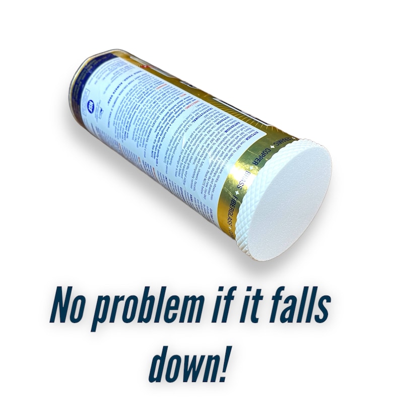 May include: A white, round, fiberglass and copper scrubber with a gold and blue label that reads "Fiberglass & Copper Scrubber". The label also includes a star and the text "No Problem If It Falls Down!" The scrubber is lying on its side.