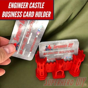 May include: Red 3D printed castle-shaped business card holder. The holder is designed to hold multiple business cards. The text "SUPERHERO DIY" is printed on the front of the holder.