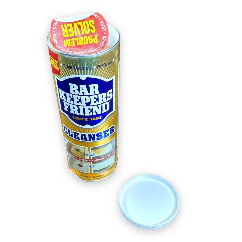 May include: A gold can of Bar Keepers Friend Cleanser with a blue label and white text. The can has a yellow lid with a red and yellow sticker that says "Problem Solver" and "Hard Water & Lime, Rust, Grime".