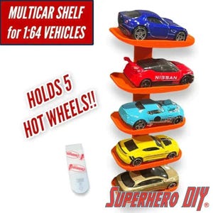 May include: An orange vertical wall-mounted display shelf with five individual tiers, each holding a 1:64 scale toy car. The text on the image reads MULTICAR SHELF for 1:64 VEHICLES, HOLDS 5 HOT WHEELS!!, and SUPERHERO DIY. Includes an adhesive mounting strip.