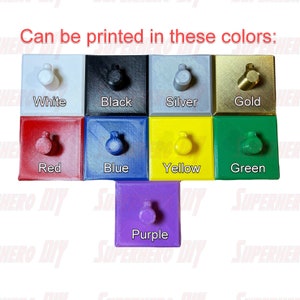 May include: A selection of small, square, 3D printed objects in various colors, including white, black, silver, gold, red, blue, yellow, green, and purple. Each object has a small knob on top.