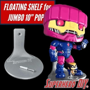 May include: A gray plastic wall mount shelf for a 10-inch jumbo Pop figure. The shelf is designed to look like a floating shelf. The shelf is labeled "SUPERHERO DIY".