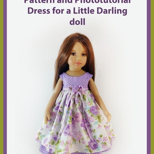 May include: PDF Pattern and Phototutorial Dress for a Little Darling doll. A doll wearing a purple and white floral dress with a purple polka dot bodice.