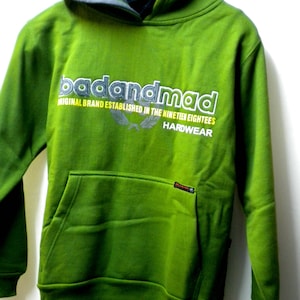 May include: Green hooded sweatshirt with the text "badandmad" in white and yellow lettering. The text "Original Brand Established in the Nineteen Eighties" is in white lettering below the logo. The text "Hardwear" is in white lettering below the text.