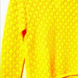 May include: A vibrant yellow, long-sleeved sweater featuring a diamond-patterned knit. The crew neck sweater has a scalloped hem. The knitwear is a solid colour, ideal for adding a bright touch to any ensemble. The garment is a cheerful, sunny yellow.