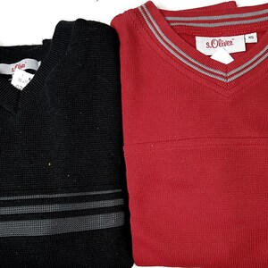 May include: Two V-neck sweaters, one black with grey stripes and one red. The red sweater has a white label with the text "s.Oliver" on it.