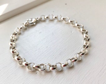 May include: A silver chain bracelet with a lobster clasp.