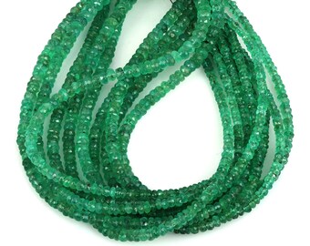 May include: A strand of emerald green gemstone beads. The beads are faceted and have a slightly irregular shape. The strand is approximately 18 inches long.