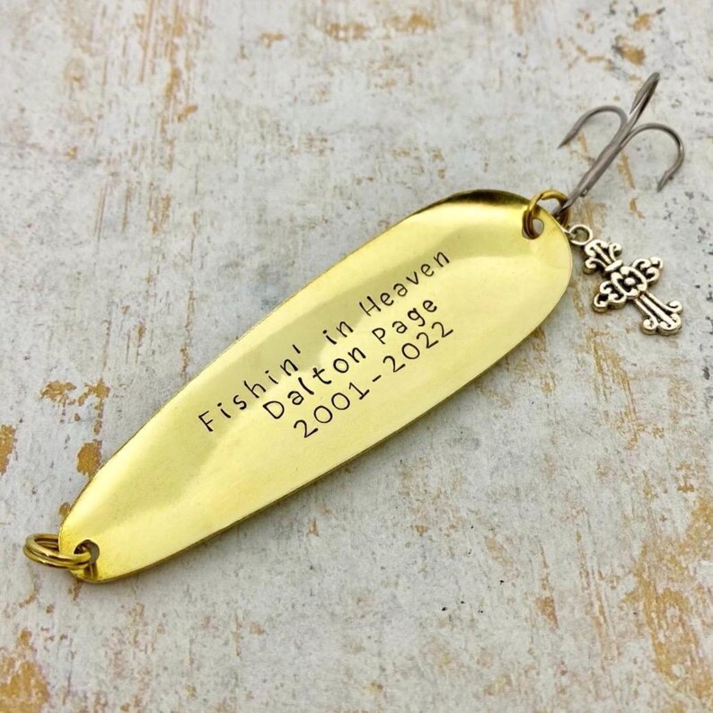 Personalized Fishin’ in Heaven memorial fishing lure with custom name and years, hand-stamped brass keepsake gift with a cross charm.