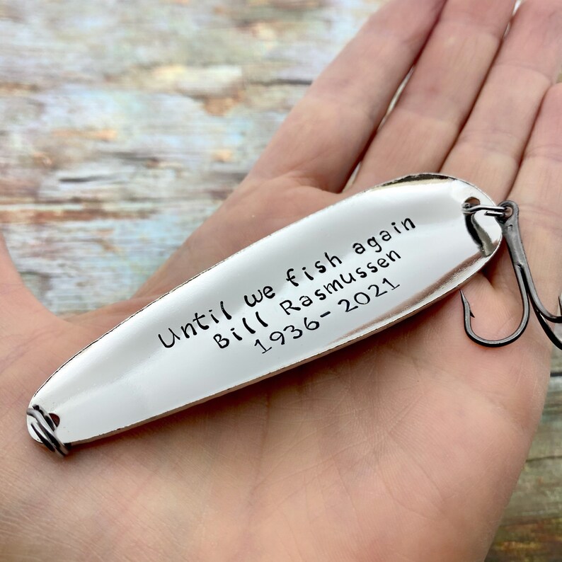 Close-up of hand-stamped lettering on personalized memorial fishing lure keepsake