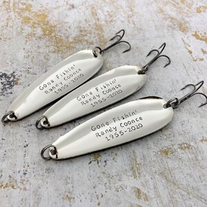 Personalized Gone Fishin’ memorial fishing lures with custom name and years, hand-stamped metal keepsake gifts.