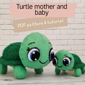 May include: A green felt turtle mother and baby with large, blue eyes and a smiling mouth. The turtles are standing on a white brick background. The text "Turtle mother and baby" and "PDF pattern & tutorial" is displayed above the turtles.