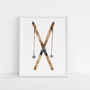 May include: A framed watercolor illustration of a pair of vintage wooden skis with black leather bindings and metal ski poles with black straps and silver tips.