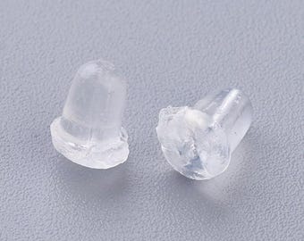 May include: Two clear, translucent earring backs. The earring backs are made of a soft, flexible material. The earring backs are designed to secure earrings in place. The earring backs are small and lightweight.
