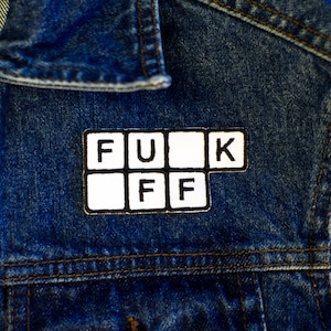 May include: A denim jacket with a white patch that says "F.U.K. OFF" in black letters.