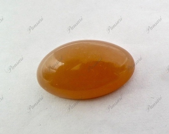 May include: A smooth, oval-shaped, amber-coloured gemstone.