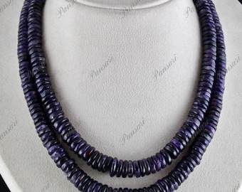 May include: A double strand necklace made of dark purple amethyst beads. The beads are round and flat, and they are strung together in a simple pattern.
