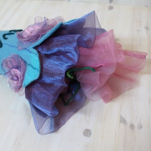 May include: A blue felt cone with pink and purple fabric flowers and layers of pink and purple tulle.