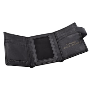 May include: Black leather trifold wallet, open to display the interior. The wallet features multiple card slots, a clear ID window, and a snap closure. The text "TO DADDY LOTS OF LOVE MIA X" is visible on the inside. The words "GENUINE LEATHER" are embossed on the inside.