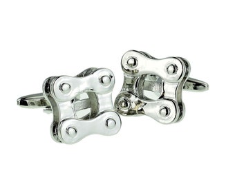 May include: A pair of silver cufflinks shaped like bicycle chain links.