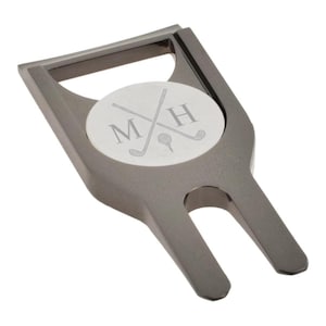 May include: A black metal golf ball retriever with a silver disc engraved with the initials "MH" and crossed golf clubs.