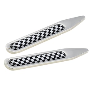 May include: Two silver car door handle covers with a black and white chequered pattern.