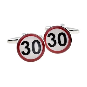 May include: A pair of silver cufflinks with a red and white circular design. The circle has a white background with a black number "30" in the centre.