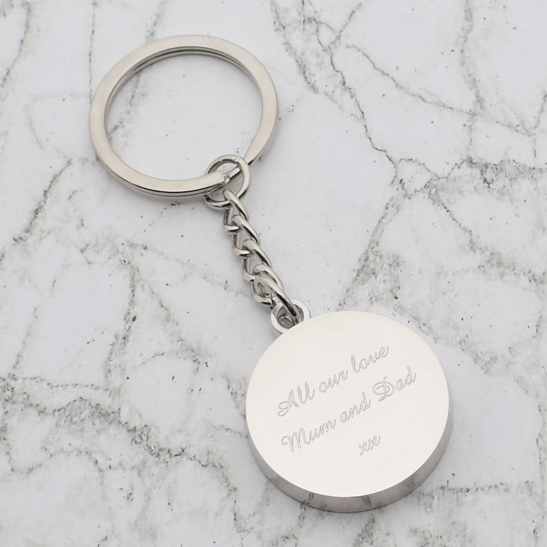 May include: Silver keychain with a round charm that says "All our love Mum and Dad xxx".