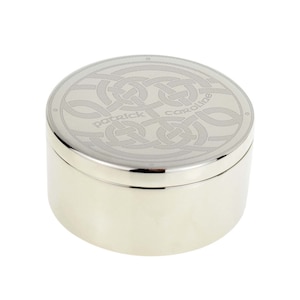 May include: A silver round box with a Celtic knot design engraved on the lid. The names "Patrick" and "Caroline" are engraved on the lid.