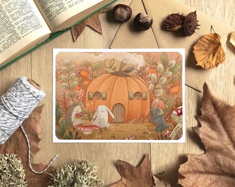 May include: A whimsical illustration of a pumpkin house with a hedgehog, a bunny, and a bird enjoying a cozy autumn scene. The pumpkin house has a door and windows, and the characters are holding treats. The background is filled with fall foliage and mushrooms.