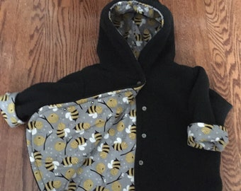 Toddlers high quality polar fleece jacket reversing to bee print. Hooded with added 2 inches on sleeves and at bottom for extra grpw room.