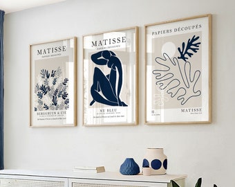 May include: Three framed art prints with a white background and blue and brown abstract designs. The prints are titled "PAPIERS DECOUPES" and "NU BLEU" and feature the artist's name "MATISSE".