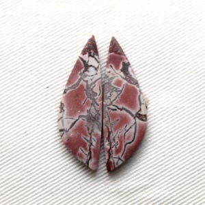 May include: Two matching marquise-shaped cabochons featuring a dusty rose and mauve base color with intricate, dark brown to black web-like veining patterns throughout the surface of each stone, creating a symmetrical pair of polished gemstones.