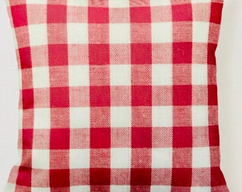 May include: Red and white checkered throw pillow. The pillow is made of a soft, woven fabric and has a square shape.