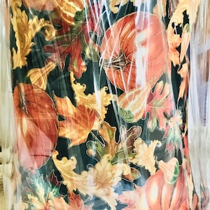 May include: A lampshade with a fall-themed design featuring pumpkins, leaves, and gourds in shades of orange, brown, gold, and green on a black background.